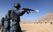 Afghan police recruits practice shooting at a firing range.