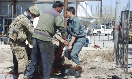 The body of a U.S. soldier is carried away from the scene of the attack. The body of a U.S. soldier is carried away from the scene of the attack.