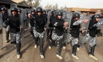 Iraqi police march during a graduation ceremony. Iraqi police march during a graduation ceremony.