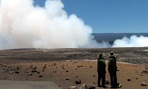 Two park rangers look out at Hawaii Volcanoes National Park.