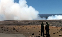 Two park rangers look out at Hawaii Volcanoes National Park.