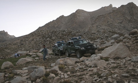 Afghan police patrol mountains outside Kabul.