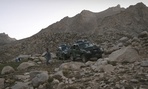 Afghan police patrol mountains outside Kabul.