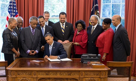 President Barack Obama signs the White House Initiative on Educational Excellence for African Americans Executive Order in the Oval Office.
