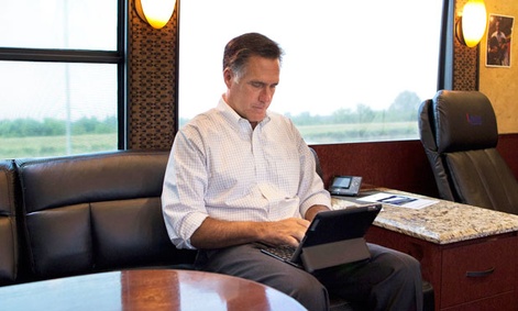 Mitt Romney works on an iPad while campaigning.