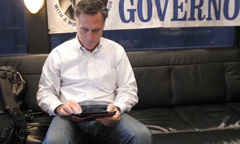 Mitt Romney uses his iPad on a bus tour in February.