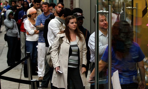 Customers wait in line to purchase the iPhone 4S in Oct. 2011.