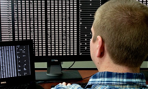 A cybersecurity analyst looks at code in the Homeland Security Department's malware laboratory.