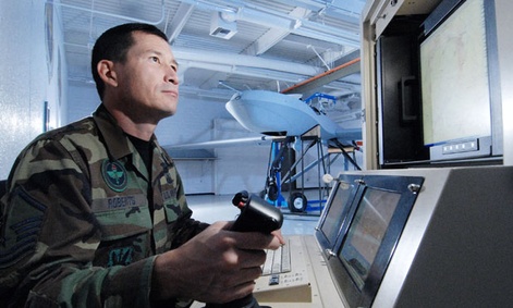 Master Sgt. Fred Roberts uses a maintenance interface station to check an MQ-1 Predator unmanned aircraft.
