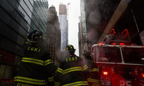 Firefighters respond to a call during the storm in New York Monday.