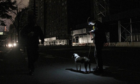 A New York woman checks her voicemail the night after the storm on her phone.