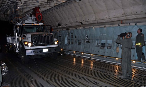 Reservists and technicians from March Air Reserve Base, Calif., load electrical equipment into a transport aircraft to send to the East Coast after the storm.