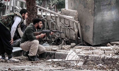 Syrian rebel fighters take cover in southeast Aleppo.