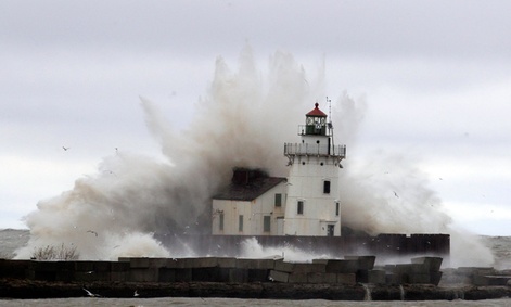 Waves pound a lighthouse as Hurricane Sandy hits the shores of Lake Erie, Tuesday.