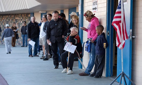 Voters wait -- and tweet on their phones -- in Las Vegas outside a poling place.