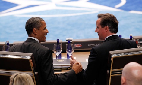 Obama and Cameron commiserate during a NATO meeting in May.