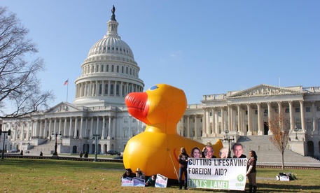 The Capitol grounds had a temporary lawn ornament Wednesday as Oxfam America activists dressed as Senate and House leaders and danced around a giant, inflatable duck to ask the lame duck session of Congress to protect foreign aid programs. 