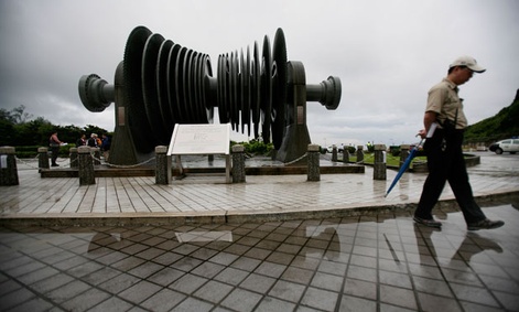 A security officer in 2011 walks past a low-pressure turbine rotor at an atomic energy site in Taiwan's Wanli district.