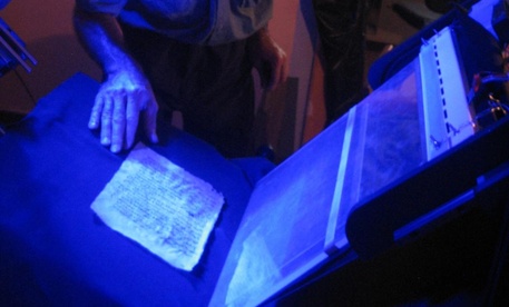 Sinai Program Manager Mike Toth examines a palimpsest leaf on spectral imaging system.