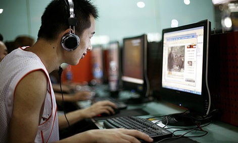 A visitor at an Internet cafe in Beijing surfs the web.