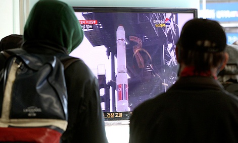 South Koreans watch a TV news program about North Korea's rocket launch plans at Seoul Railway Station in Seoul, South Korea.
