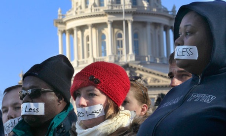 Protestors line up near the Michigan state capitol in East Lansing Wednesday. Protestors line up near the Michigan state capitol in East Lansing Wednesday.