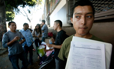 Illegal immigrant Layios Roberto waits with papers outside the offices of Coalition for Humane Immigrant Rights in Los Angeles Wednesday, Aug. 15, 2012.