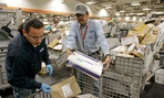 Postal employees sort mail in San Francisco in 2007.