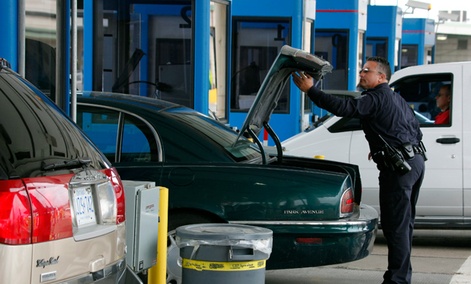 U.S. Customs and Border Patrol officer Jefferey Hill checks the trunk of a motorist's vehicle entering the United States at the border crossing in Buffalo, N.Y.