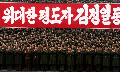 North Korean soldiers applaud during a mass rally organized to celebrate the success of a rocket launch.