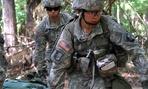 Capt. Sara Rodriguez, 26, of the 101st Airborne Division, carries a litter of sandbags during the Expert Field Medical Badge training at Fort Campbell, Ky.