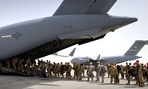 U.S. soldiers get in to a U.S. military plane, as they leave Afghanistan, at the U.S. base in Bagram, north of Kabul, Afghanistan.