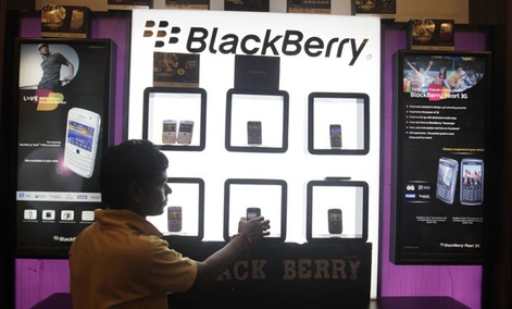 A shopkeeper displays BlackBerry mobile phones in his shop in Ahmadabad, India in 2010.