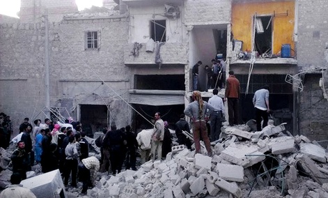 In this Monday, March 18, 2013, citizen journalism image Syrian citizens stand on rubble of houses that were destroyed due to Syrian forces airstrikes.