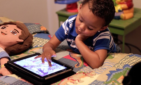 Frankie Thevenot, 3, plays with an iPad in his bedroom at his home in Metairie, La.