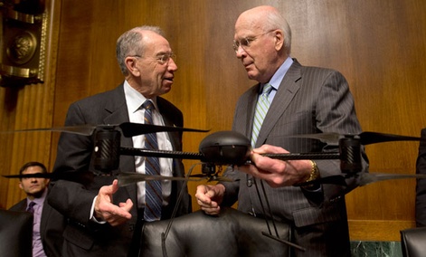 Sen. Patrick Leahy, D-Vt., holds an example of a drone, as he talks with the Sen. Charles Grassley, R-Iowa, Wednesday.