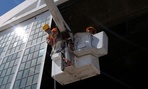 Service members fix lights atop a hangar at Coast Guard Station Borinquen in Puerto Rico. Service members fix lights atop a hangar at Coast Guard Station Borinquen in Puerto Rico.