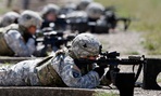 Female soldiers from 1st Brigade Combat Team, 101st Airborne Division train on a firing range in 2012