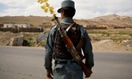 An Afghan National Police officer watches over a checkpoint