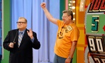 A contestant stands next to the "Big Wheel" during a taping of the Price is Right. When mail carrier Cathy Wrench Cashwell appeared on the same show, officials discovered she was more mobile than her workers compensation claims suggested. 