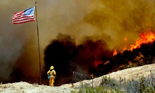 A firefighter watches a wildfire northeast of Castaic, Calif., in May.