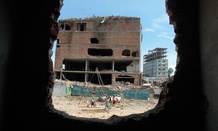 Laborers work at the site where a Bangladesh garment-factory building collapsed in April.
