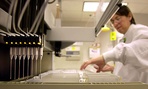 A technician loads patient samples into a machine for testing at Myriad Genetics. 