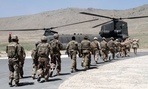 NATO soldiers walk towards a Chinook helicopter after a ceremony at a military academy on the outskirts of Kabul, Afghanistan.