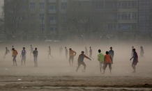 Afghan boys play football in the city of Kabul, Afghanistan, Monday, Dec. 29, 2014.