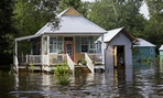 Floodwaters reach the front steps of a home near Holden, Louisiana.