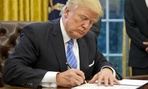 President Trump signs executive orders on Jan. 23. 
