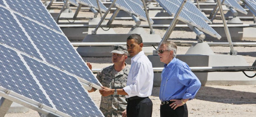 Flanked by Senate Majority Leader Harry Reid, D-Nev., and Col. Howard Belote, Obama examined solar energy at Las Vegas' Nellis Air Force Base in 2009.