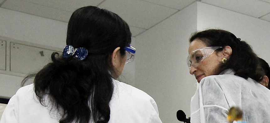 Commissioner of Food and Drugs Margaret Hamburg asks a worker a question in a Chinese food safety lab in 2010. 