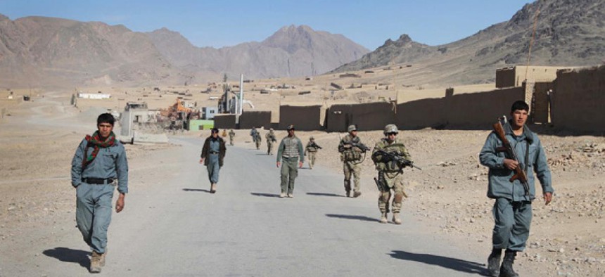Afghan policemen and U.S. soldiers patrol Kandahar in January.